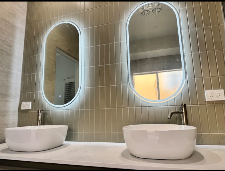 Backlit LED mirrors and power points in a renovated bathroom