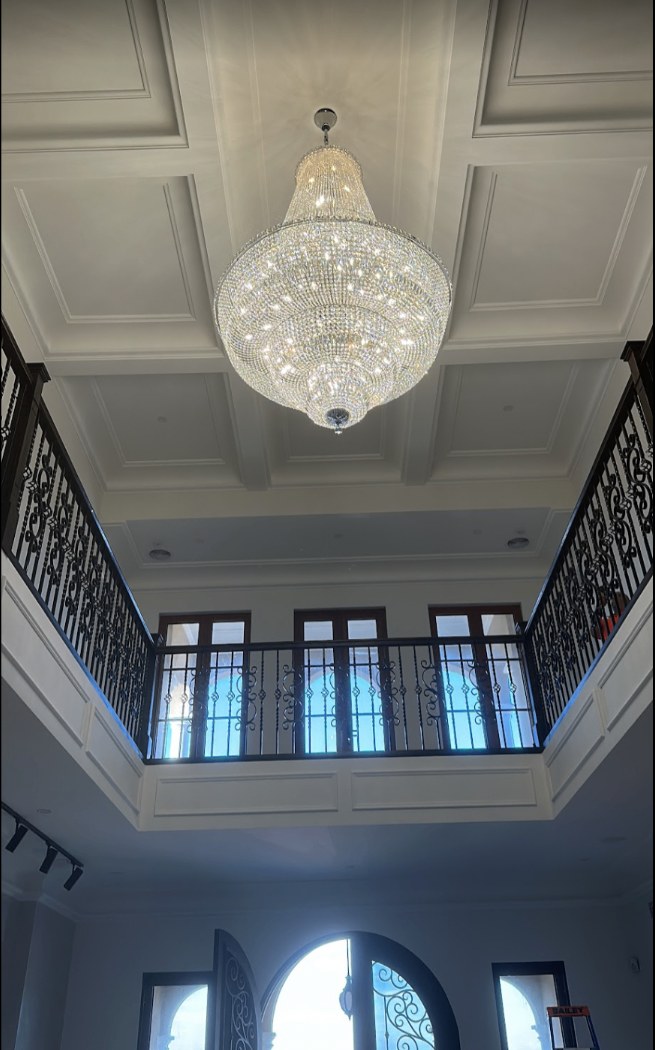 Chandelier installed in a double-height entry void